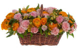 Basket of Orange Ranunculus in Pink